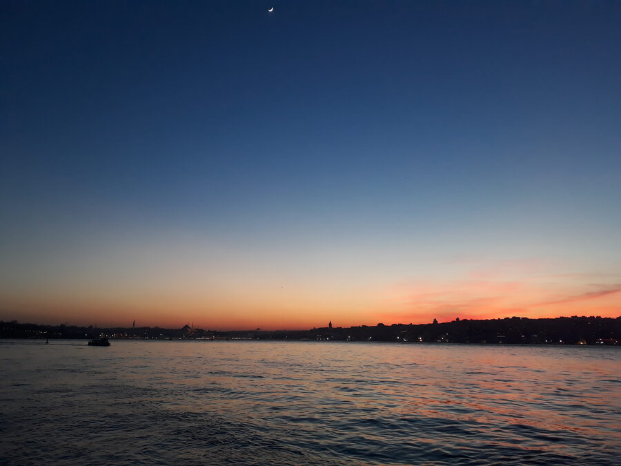 The Istanbul city skyline at sunset, seen from beside the Bosphorus